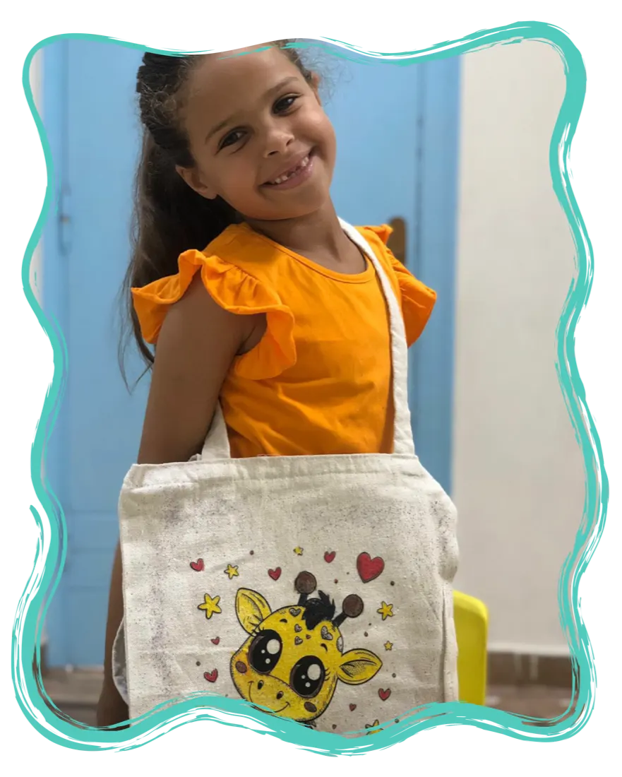 A girl holding the bag she decorated