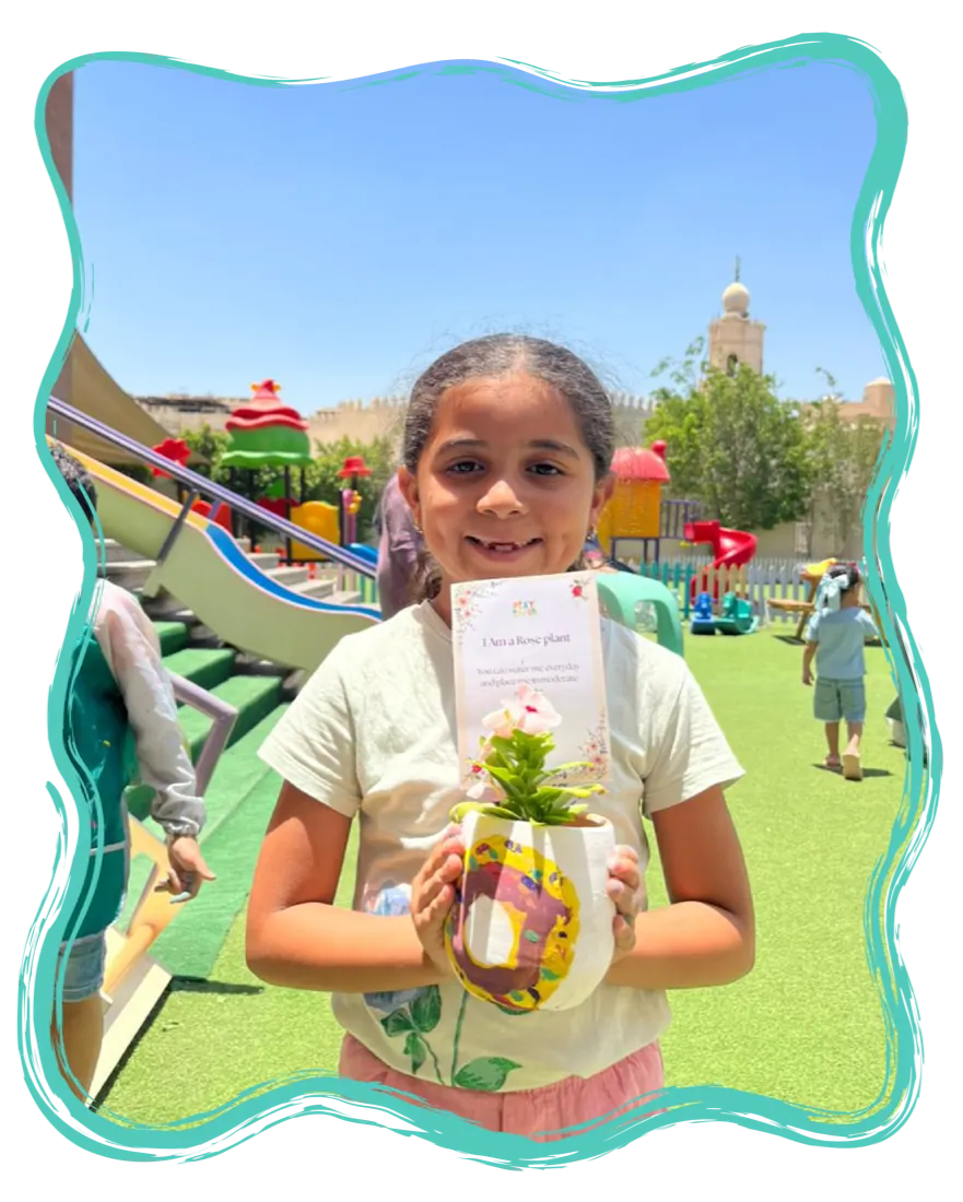 A child holding a plant they potted